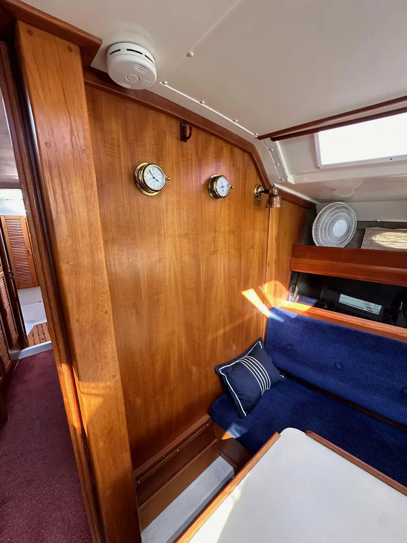 Slide: The Image of Interior of 1987 Hunter Legend 45 sailboat with wooden paneling and blue seating. - 47