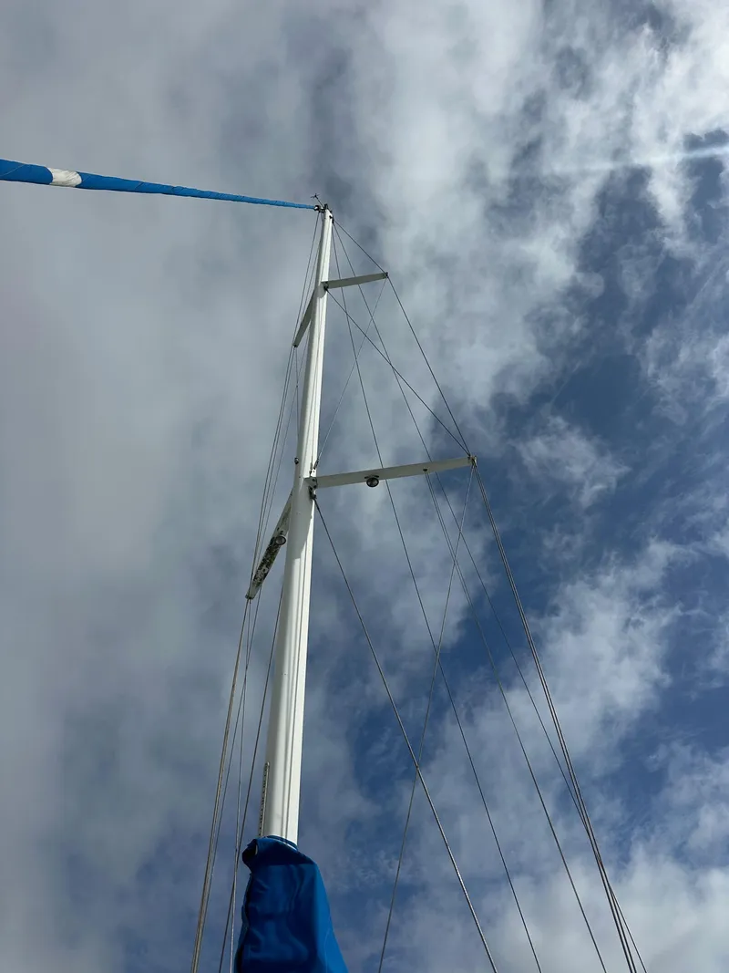 Slide: The Image of Mast of 1987 Hunter Legend 45 sailboat against cloudy sky. - 5