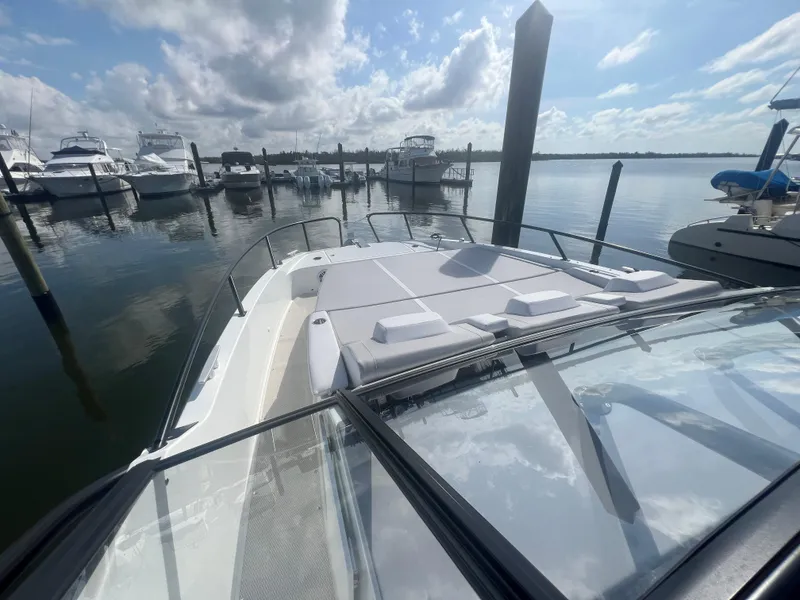 Slide: The Image of 2025 Beneteau Flyer 10 docked at marina under cloudy sky. - 11