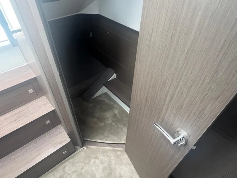 Slide: The Image of Interior cabin view of 2025 Beneteau Flyer 10, featuring modern wood finishes and carpeted flooring. - 24