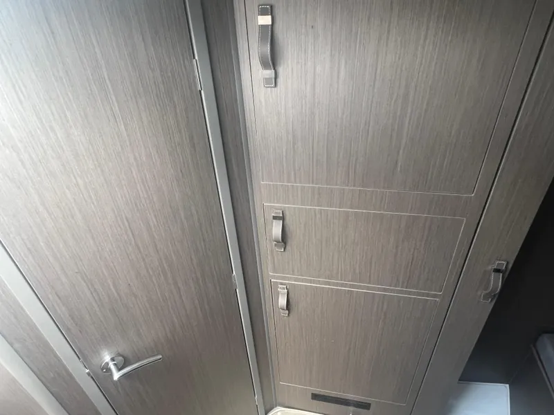 Slide: The Image of Interior cabinetry of 2025 Beneteau Flyer 10, featuring sleek wood finish and modern handles. - 25