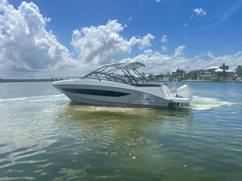 Slide: The Image of 2025 Beneteau Flyer 10 boat cruising on a sunny day with scenic waterfront views. - 6