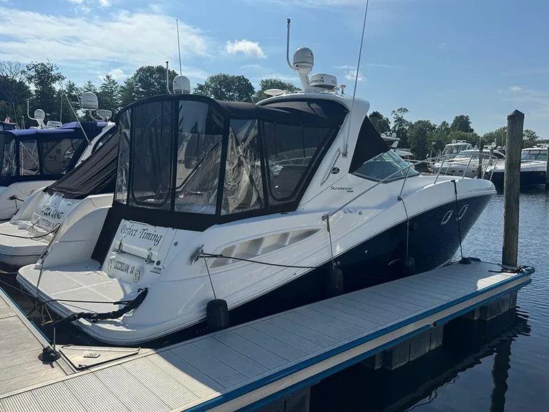 The Image of 2009 Sea Ray 330 Sundancer docked at marina, featuring sleek design and covered cockpit. - 1
