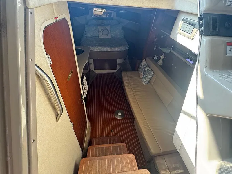 Slide: The Image of Interior of 2009 Sea Ray 330 Sundancer, featuring cozy seating and wooden flooring. - 10