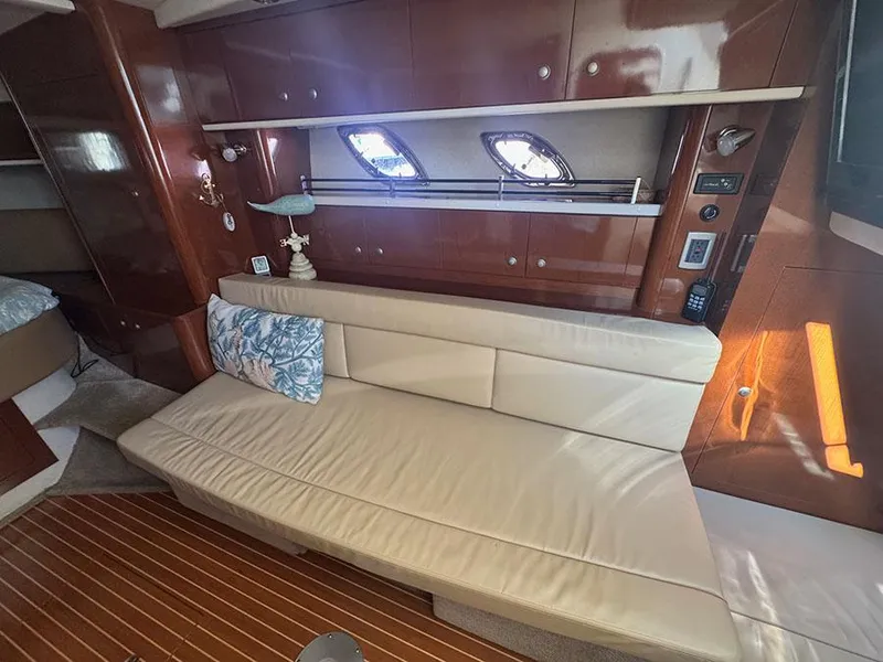 Slide: The Image of Luxurious interior of 2009 Sea Ray 330 Sundancer with cream leather seating and wooden accents. - 11