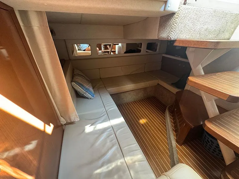 Slide: The Image of 2009 Sea Ray 330 Sundancer cabin interior with seating and wooden flooring. - 14