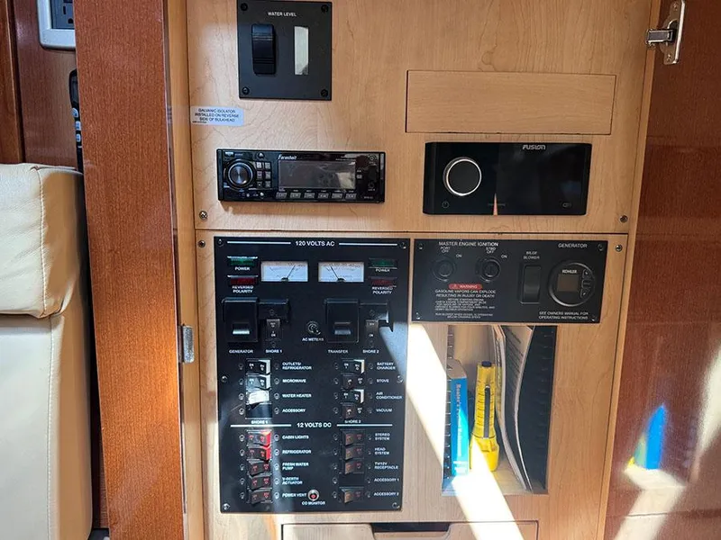 Slide: The Image of Control panel of a 2009 Sea Ray 330 Sundancer boat with various switches and gauges. - 18