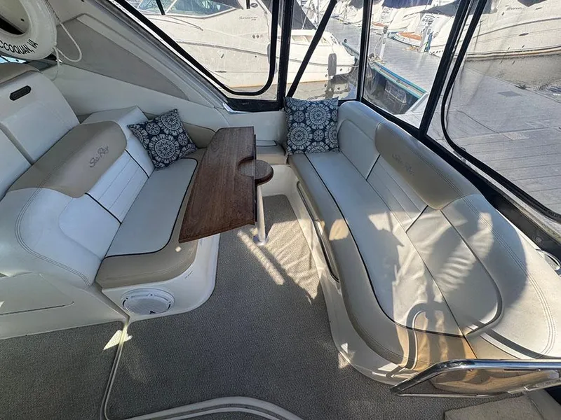 Slide: The Image of Interior of 2009 Sea Ray 330 Sundancer with cushioned seating and wooden table. - 5