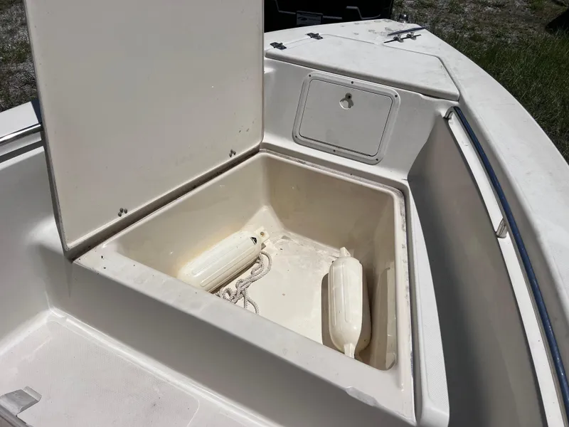 Slide: The Image of Open storage compartment on 2000 Scout 185 Sportfish boat, showing fender and rope. - 19
