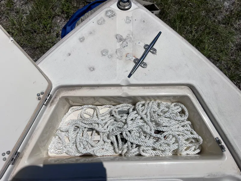 Slide: The Image of Open storage compartment on 2000 Scout 185 Sportfish boat with coiled rope inside. - 20