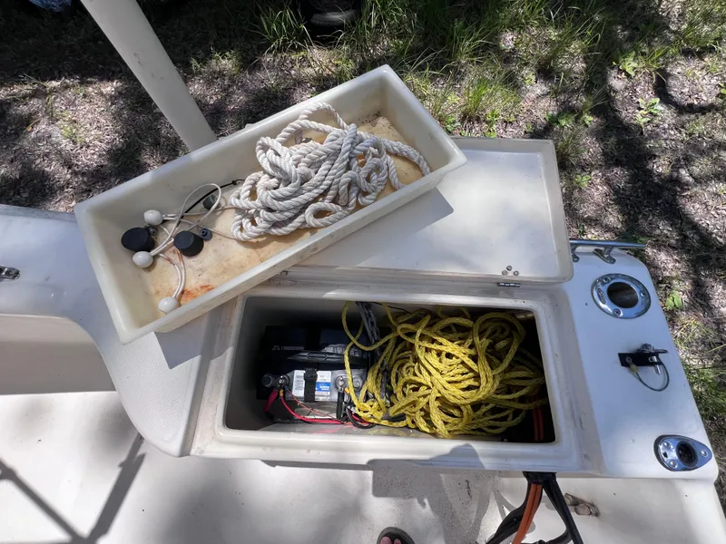 Slide: The Image of Scout 185 Sportfish 2000 boat storage with ropes and battery compartment. - 25