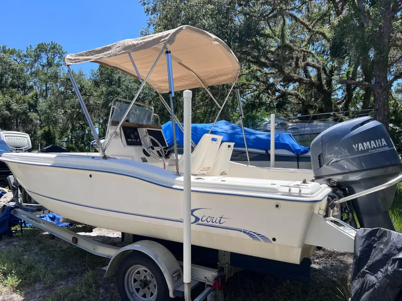 Slide: The Image of 2000 Scout 185 Sportfish boat with Yamaha engine on trailer, parked outdoors. - 3