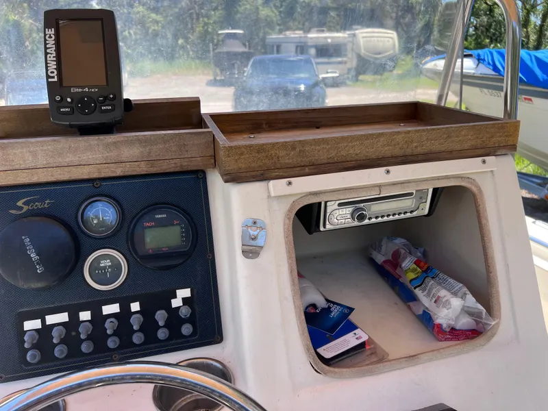 Slide: The Image of Console of a 2000 Scout 185 Sportfish boat with gauges and a Lowrance device. - 30