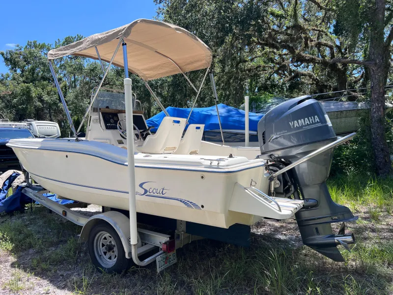 Slide: The Image of 2000 Scout 185 Sportfish boat with Yamaha outboard motor on trailer, parked outdoors. - 4