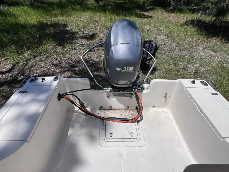 Slide: The Image of 2000 Scout 185 Sportfish boat with Yamaha 115 outboard motor in grassy area. - 7