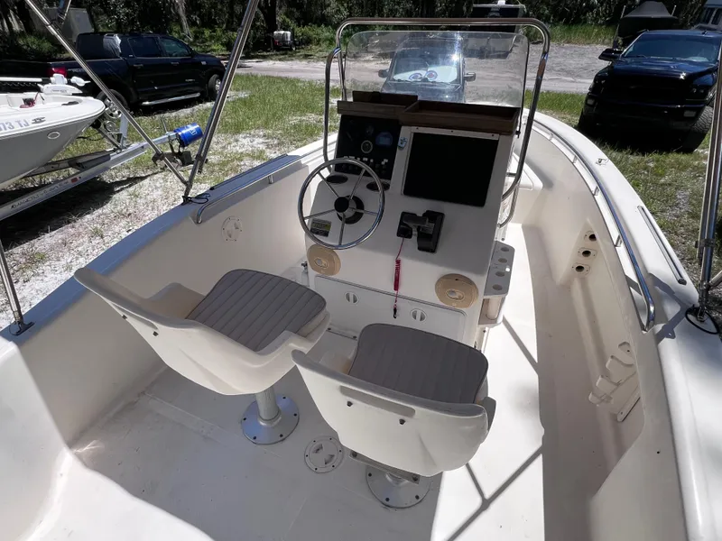 Slide: The Image of 2000 Scout 185 Sportfish boat interior with steering console and seating. - 8