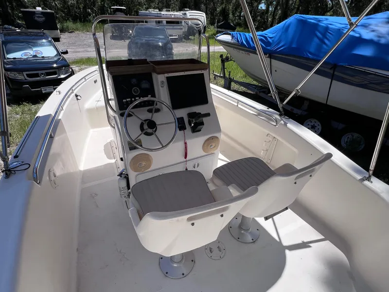 Slide: The Image of 2000 Scout 185 Sportfish boat interior with steering console and dual seats. - 9
