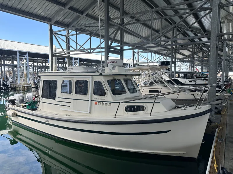 The Image of 2007 Rosborough R-246 boat docked in a marina under a metal roof. - 1