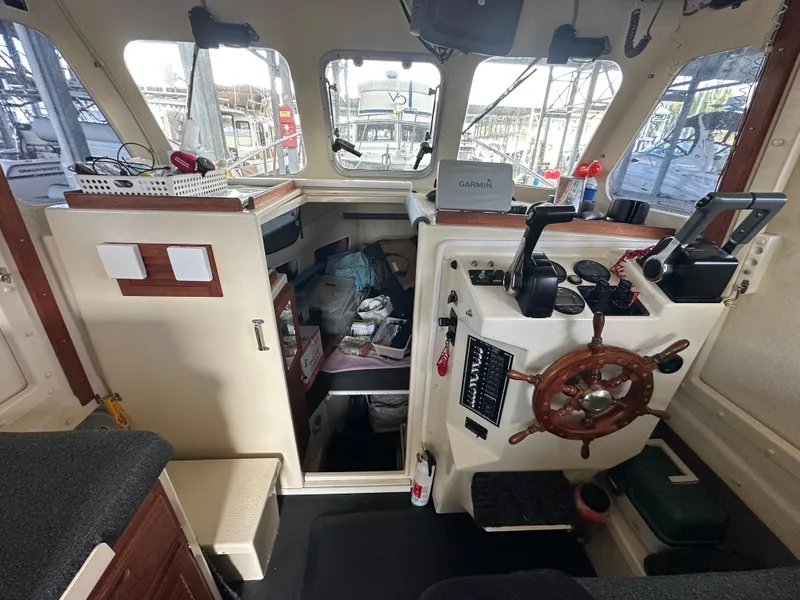 Slide: The Image of Interior of 2007 Rosborough R-246 boat with steering wheel and control panel. - 10