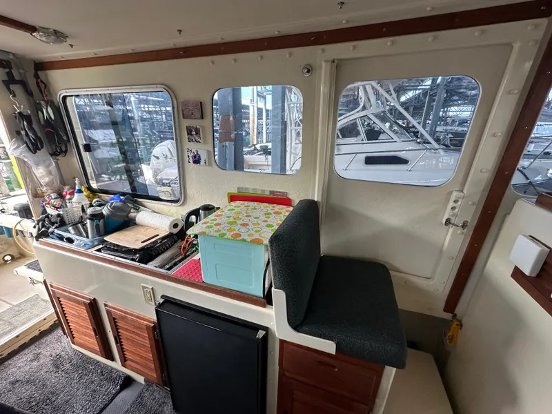 Slide: The Image of Interior of a 2007 Rosborough R-246 boat with kitchenette and seating area. - 11
