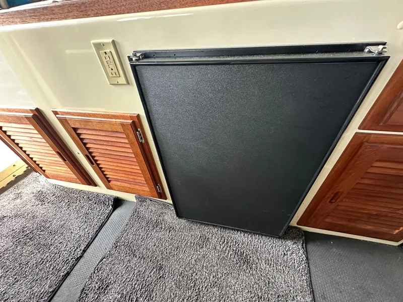 Slide: The Image of Interior of 2007 Rosborough R-246 with wooden cabinets and carpeted flooring. - 12