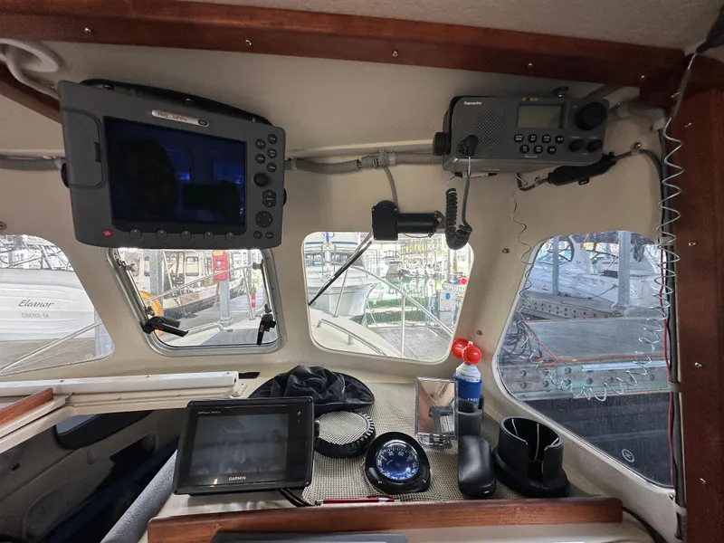 Slide: The Image of Interior of 2007 Rosborough R-246 boat with navigation equipment and controls. - 14