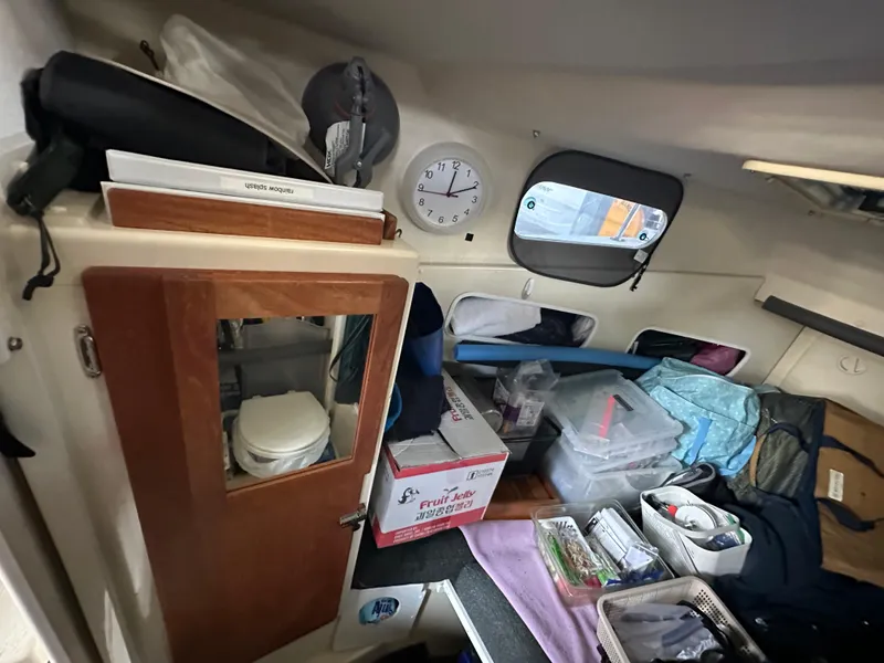 Slide: The Image of Interior of 2007 Rosborough R-246 boat with storage, clock, and organized supplies. - 17