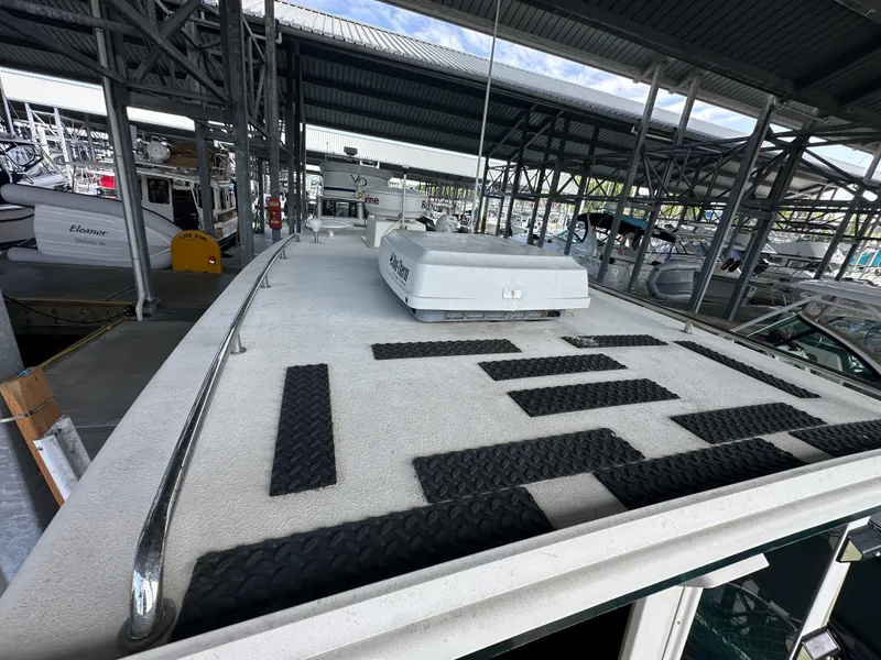 Slide: The Image of 2007 Rosborough R-246 boat docked in a covered marina, featuring non-slip deck pads. - 3