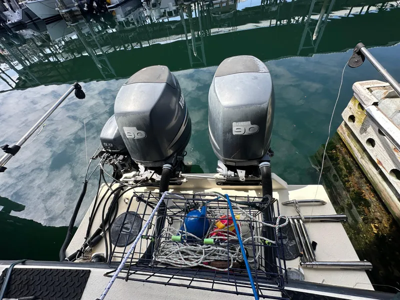 Slide: The Image of Twin Yamaha 90 outboard motors on a 2007 Rosborough R-246 boat at a dock. - 7