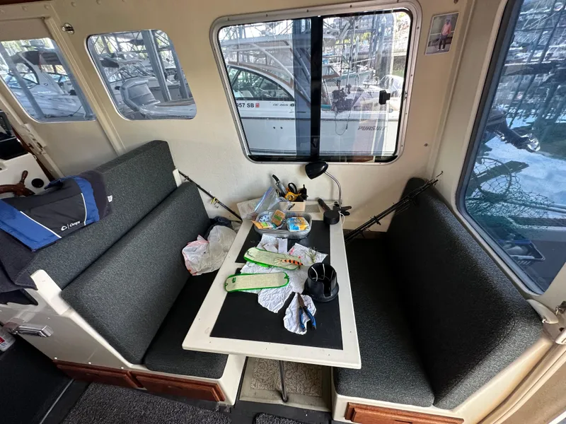 Slide: The Image of Interior of 2007 Rosborough R-246 boat with table, seating, and fishing gear. - 9