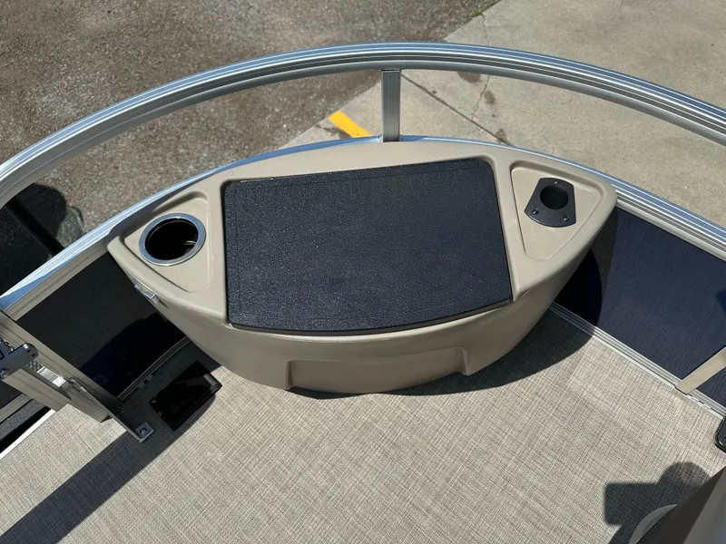 Slide: The Image of 2025 Sun Tracker Bass Buggy 18 DLX boat deck with cup holders and railing. - 10