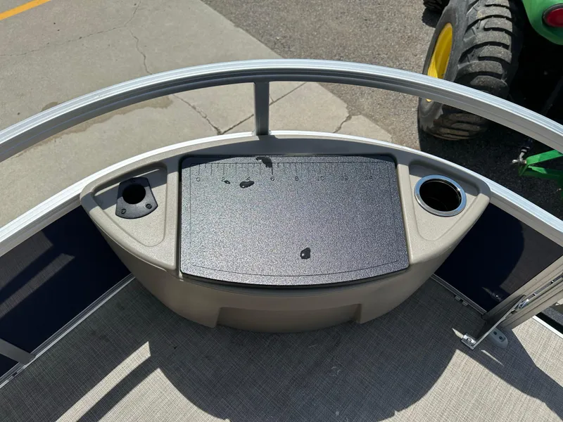 Slide: The Image of 2025 Sun Tracker Bass Buggy 18 DLX boat deck with cup holders and storage compartment. - 11