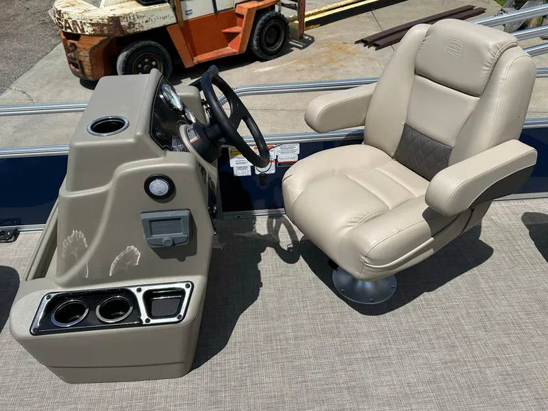 Slide: The Image of 2025 Sun Tracker Bass Buggy 18 DLX helm with beige captain's chair and control panel. - 17