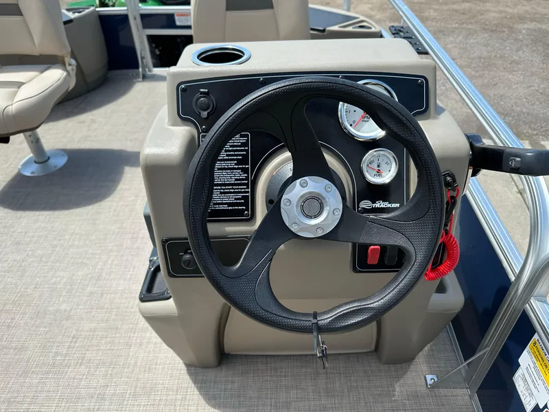 Slide: The Image of 2025 Sun Tracker Bass Buggy 18 DLX steering console with gauges and controls. - 19