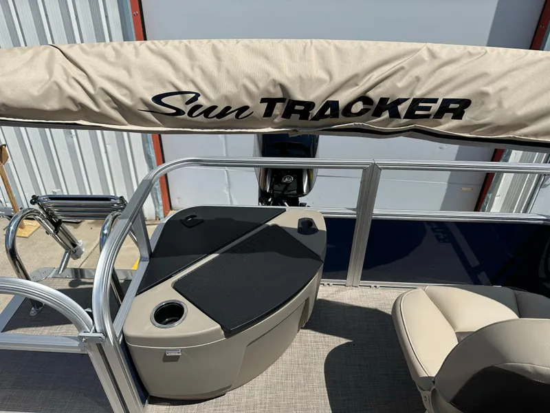 Slide: The Image of 2025 Sun Tracker Bass Buggy 18 DLX pontoon boat interior with seating and console. - 25