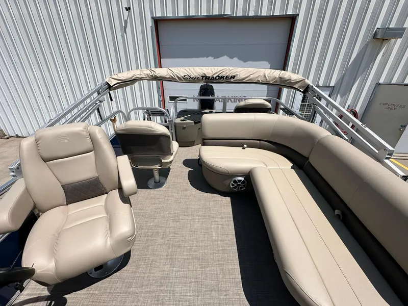 Slide: The Image of 2025 Sun Tracker Bass Buggy 18 DLX pontoon boat with beige seating and canopy. - 29