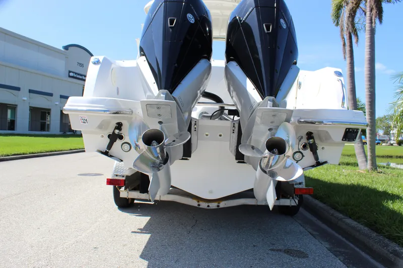 Slide: The Image of 2018 Boston Whaler 270 Vantage boat with dual outboard engines, parked near a building. - 12