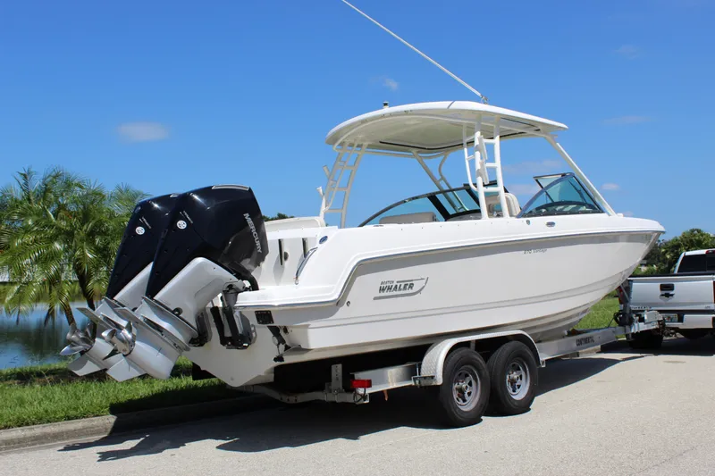 Slide: The Image of 2018 Boston Whaler 270 Vantage boat on trailer, dual Mercury engines, sunny day. - 20