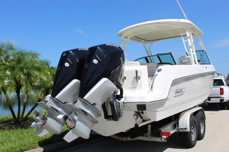 Slide: The Image of 2018 Boston Whaler 270 Vantage boat on trailer with dual outboard engines. - 21
