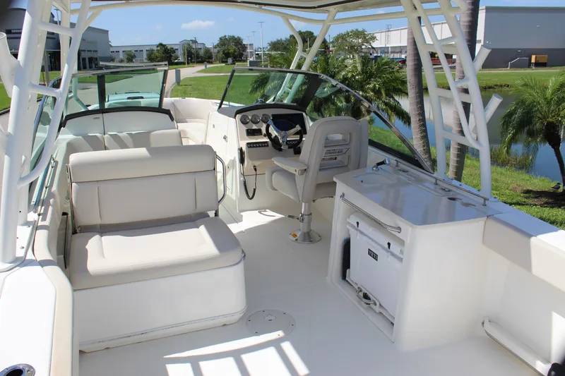 Slide: The Image of 2018 Boston Whaler 270 Vantage boat interior with seating and helm, showcasing luxury design. - 28