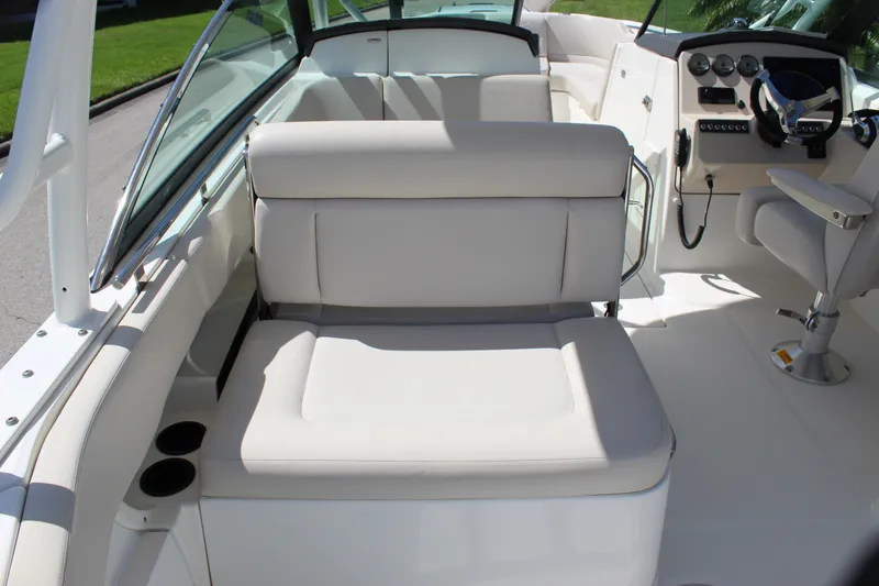 Slide: The Image of 2018 Boston Whaler 270 Vantage interior with cushioned seating and helm controls. - 30