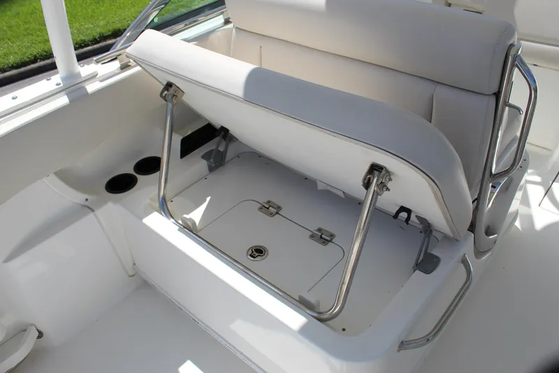 Slide: The Image of 2018 Boston Whaler 270 Vantage boat seat with storage compartment open. - 31