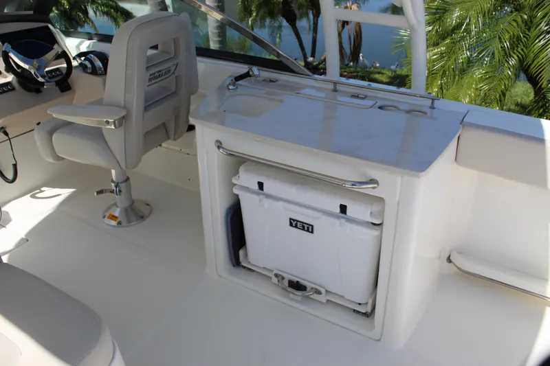Slide: The Image of 2018 Boston Whaler 270 Vantage interior with helm seat and Yeti cooler. - 35