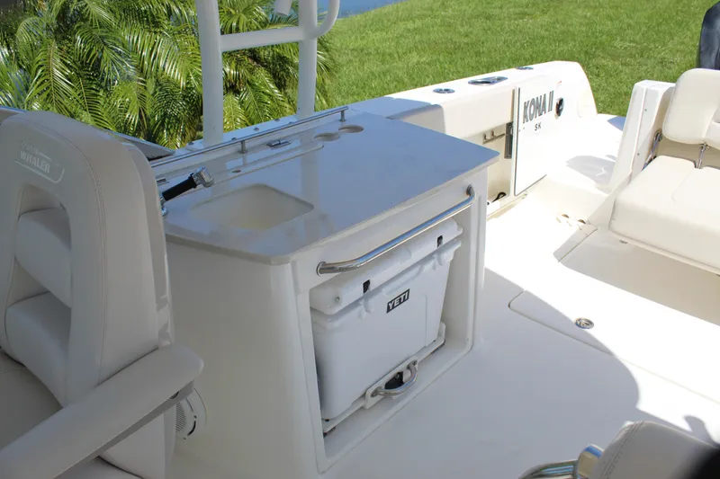 Slide: The Image of 2018 Boston Whaler 270 Vantage interior with seating, sink, and Yeti cooler. - 36