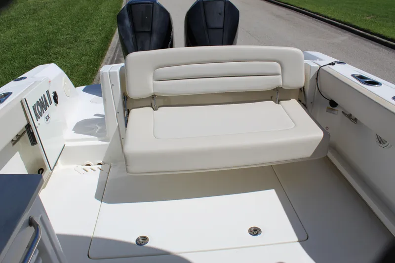 Slide: The Image of 2018 Boston Whaler 270 Vantage boat with cushioned seating and dual outboard motors. - 39
