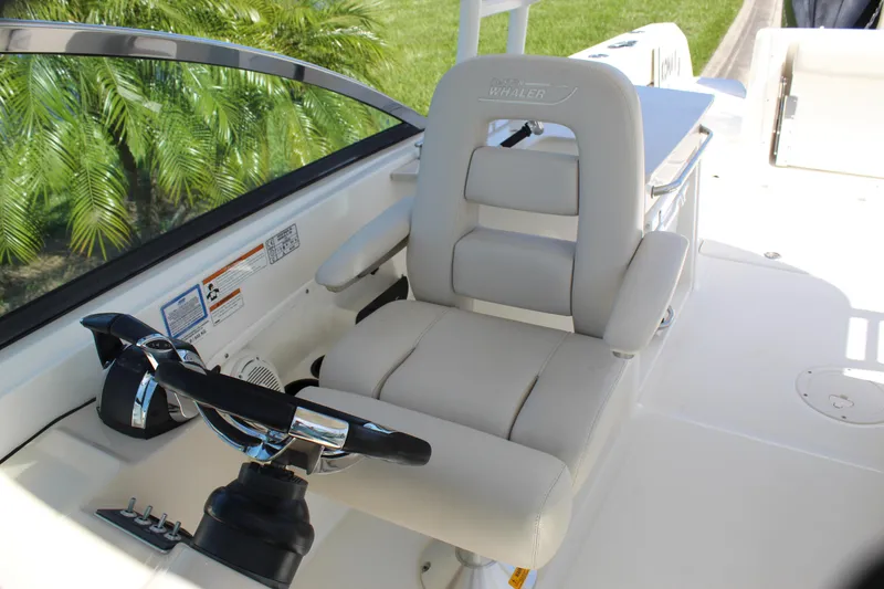 Slide: The Image of 2018 Boston Whaler 270 Vantage helm seat with steering wheel and controls. - 44