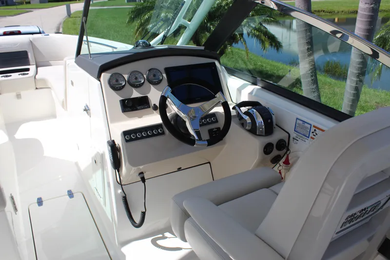 Slide: The Image of 2018 Boston Whaler 270 Vantage boat cockpit with steering wheel and control panel. - 47