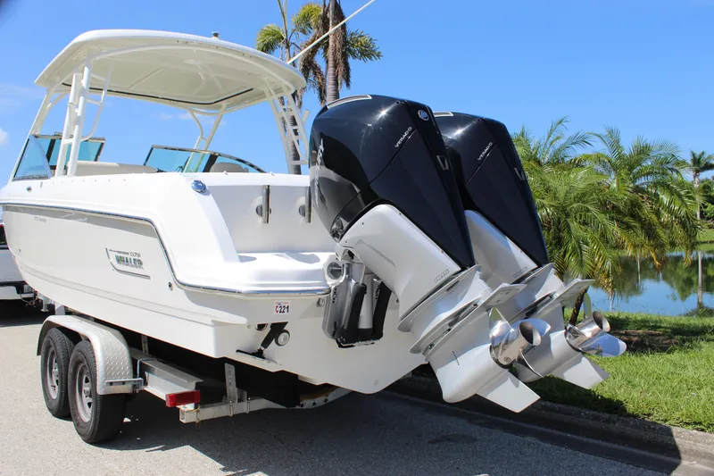 Slide: The Image of 2018 Boston Whaler 270 Vantage boat on trailer, dual outboard engines, sunny day. - 9
