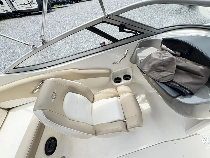 Slide: The Image of 2016 Stingray 188 LX boat interior with beige seating and storage compartment. - 11