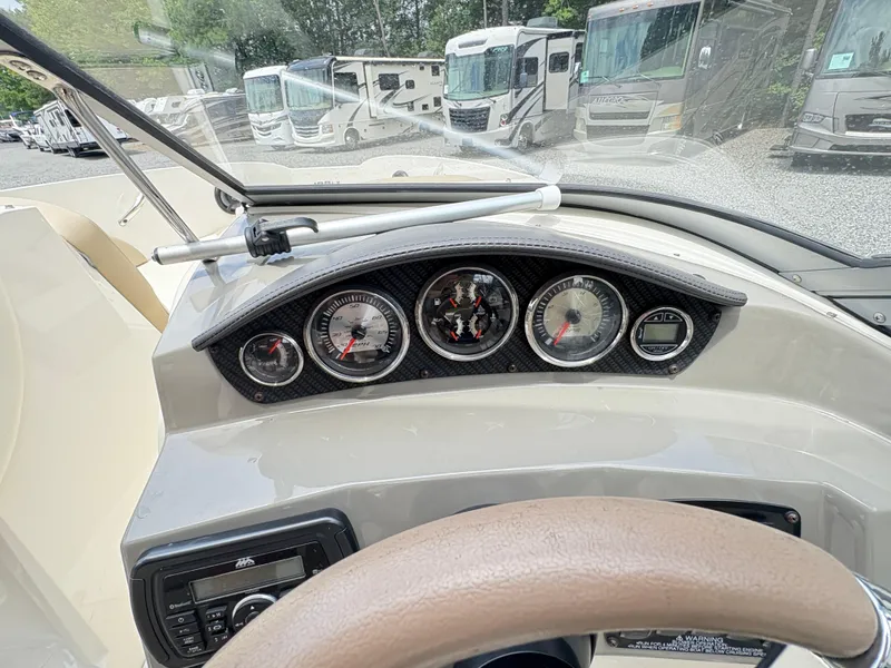 Slide: The Image of Dashboard of a 2016 Stingray 188 LX boat with gauges and steering wheel. - 13